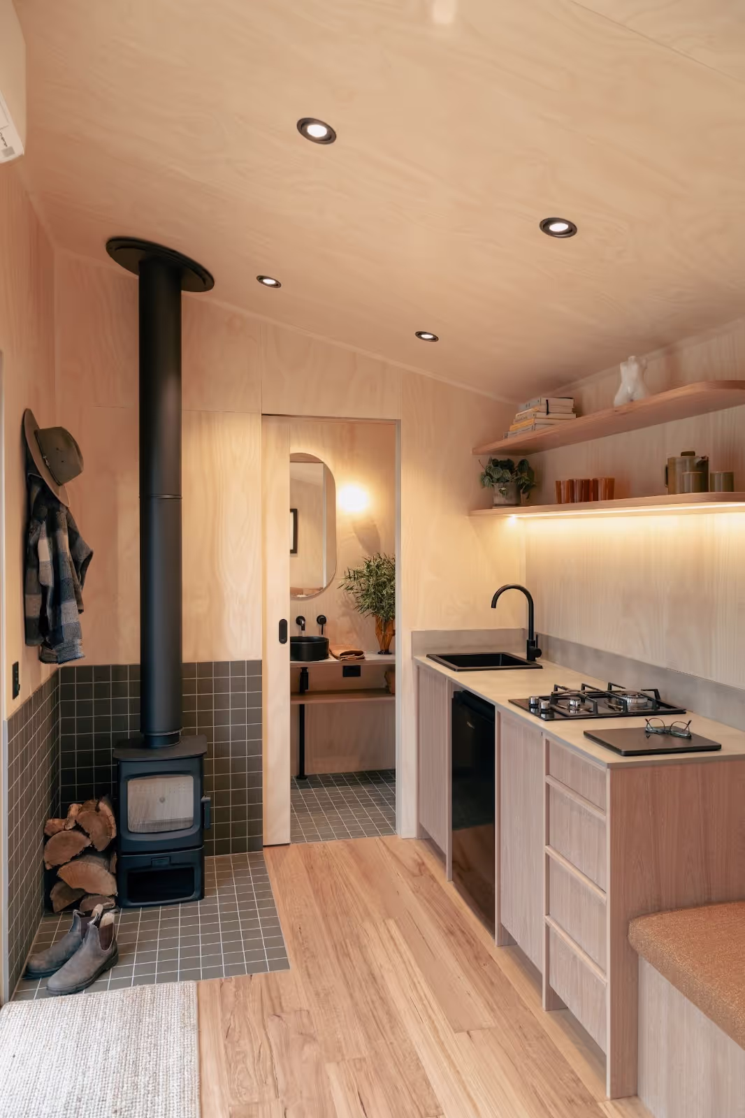 tall tiny house kitchen area with fireplace