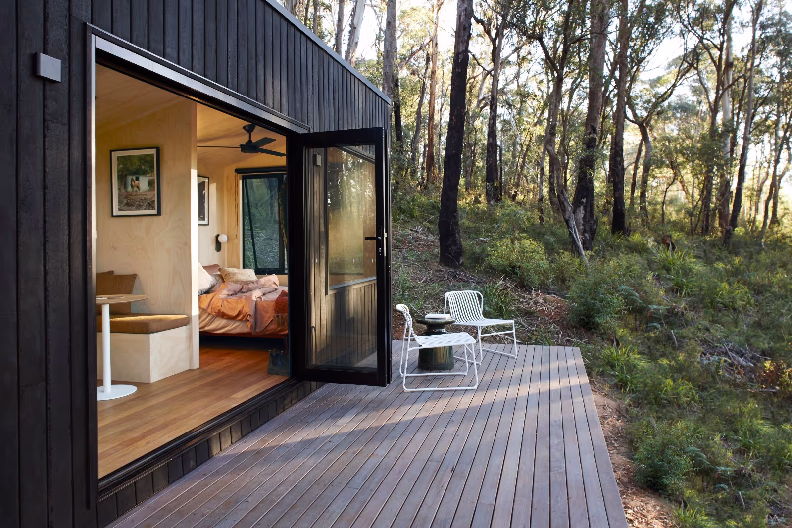 tall tiny house with a large deck in the australian bush